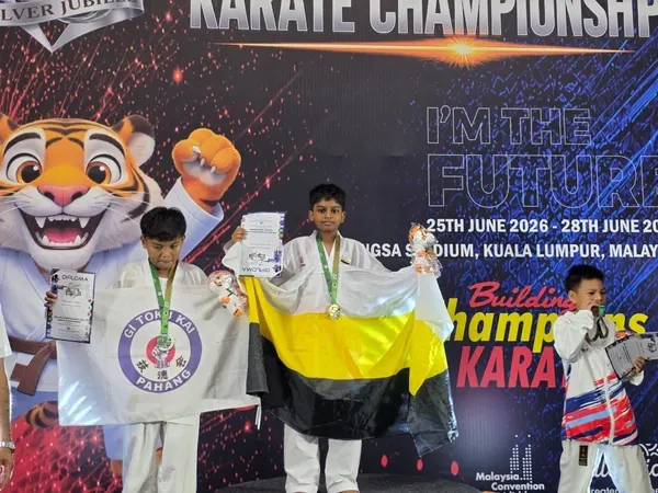 Perak Legends student on the podium holding the Perak flag